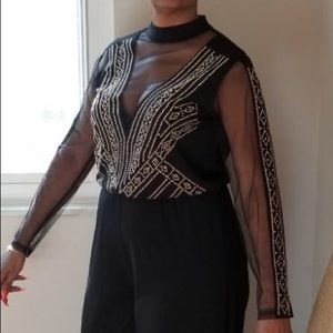 Black studded jumpsuit with sheer sleeves